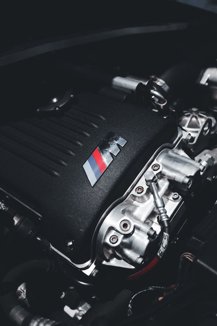 Detailed view of a high-performance engine in a car, showcasing power and engineering precision.