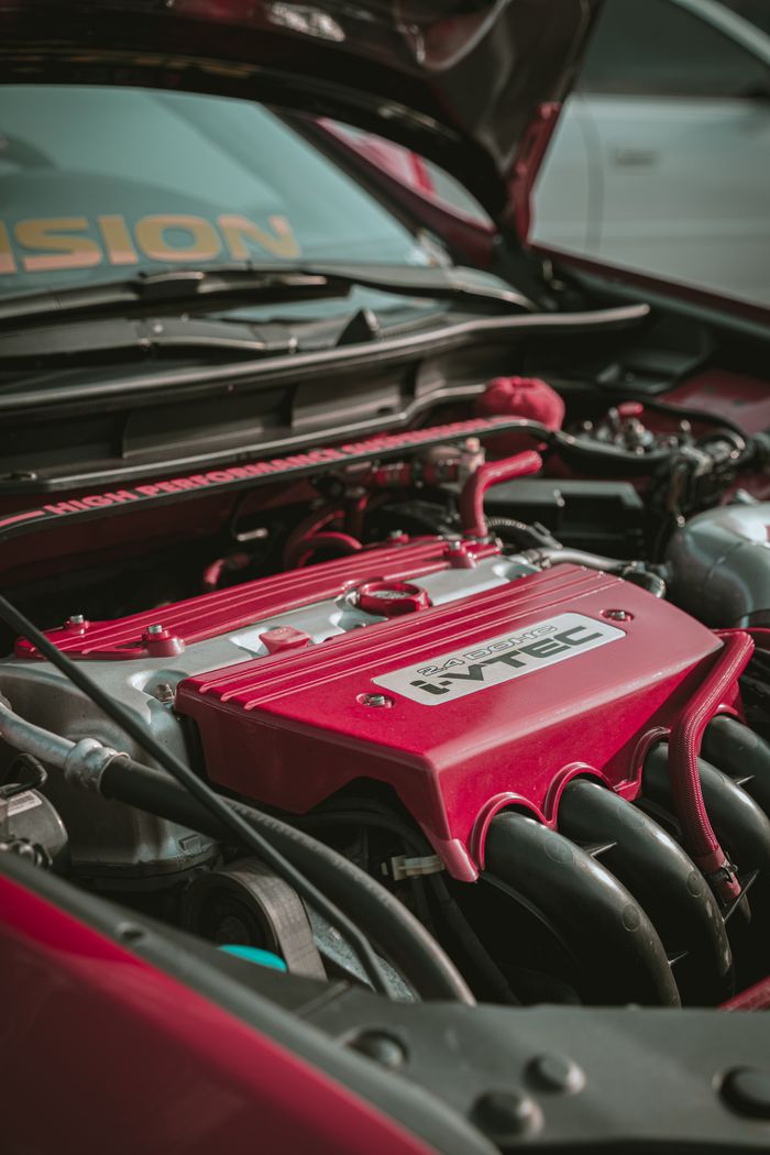Detailed view of a Honda I-Vtec engine bay showcasing automotive engineering.